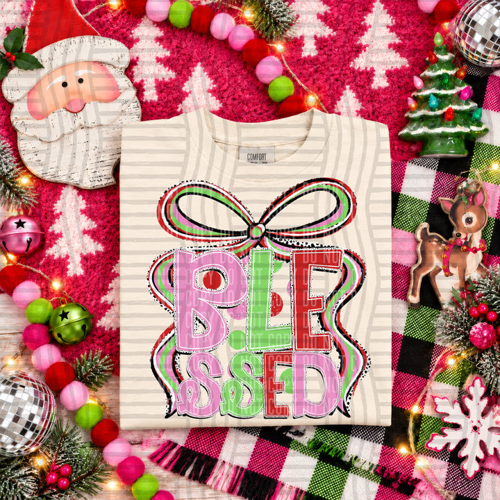 Blessed Christmas Bow DTF transfer pressed on a tee