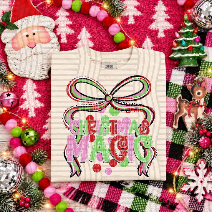 Christmas Magic Christmas Bow DTF transfer pressed on a tee
