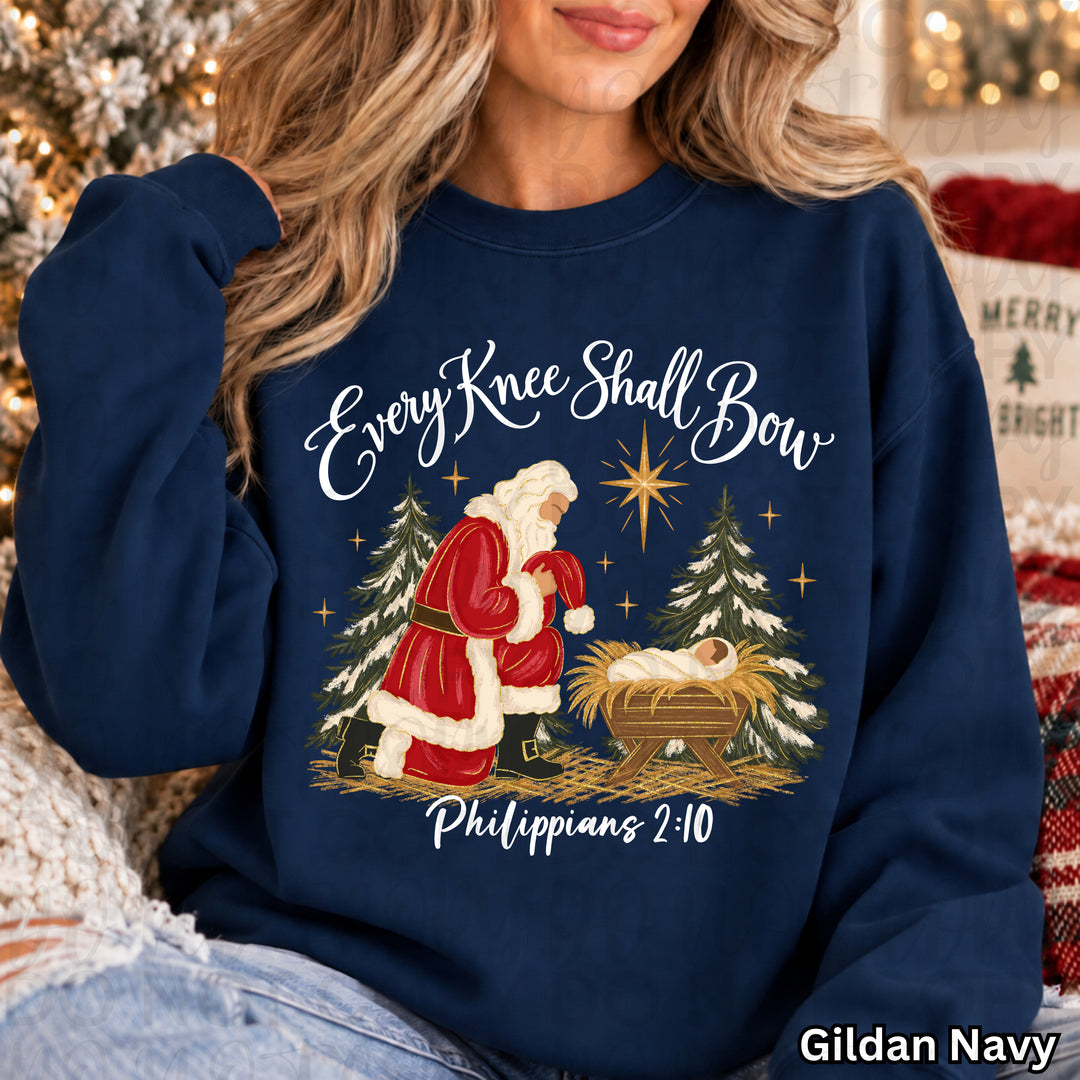 Every Knee Shall Bow White Christmas DTF transfer mockup on a navy sweatshirt