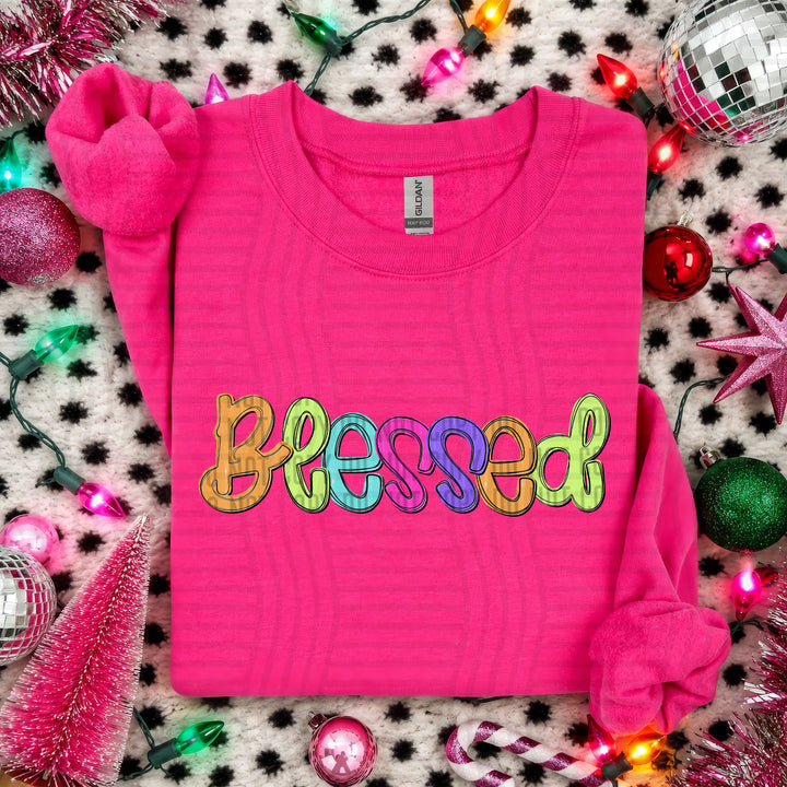 Blessed Script Christmas DTF transfer shown on a pink sweater