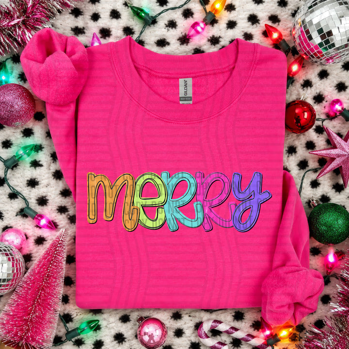 Merry Script Christmas DTF transfer shown on a pink sweater