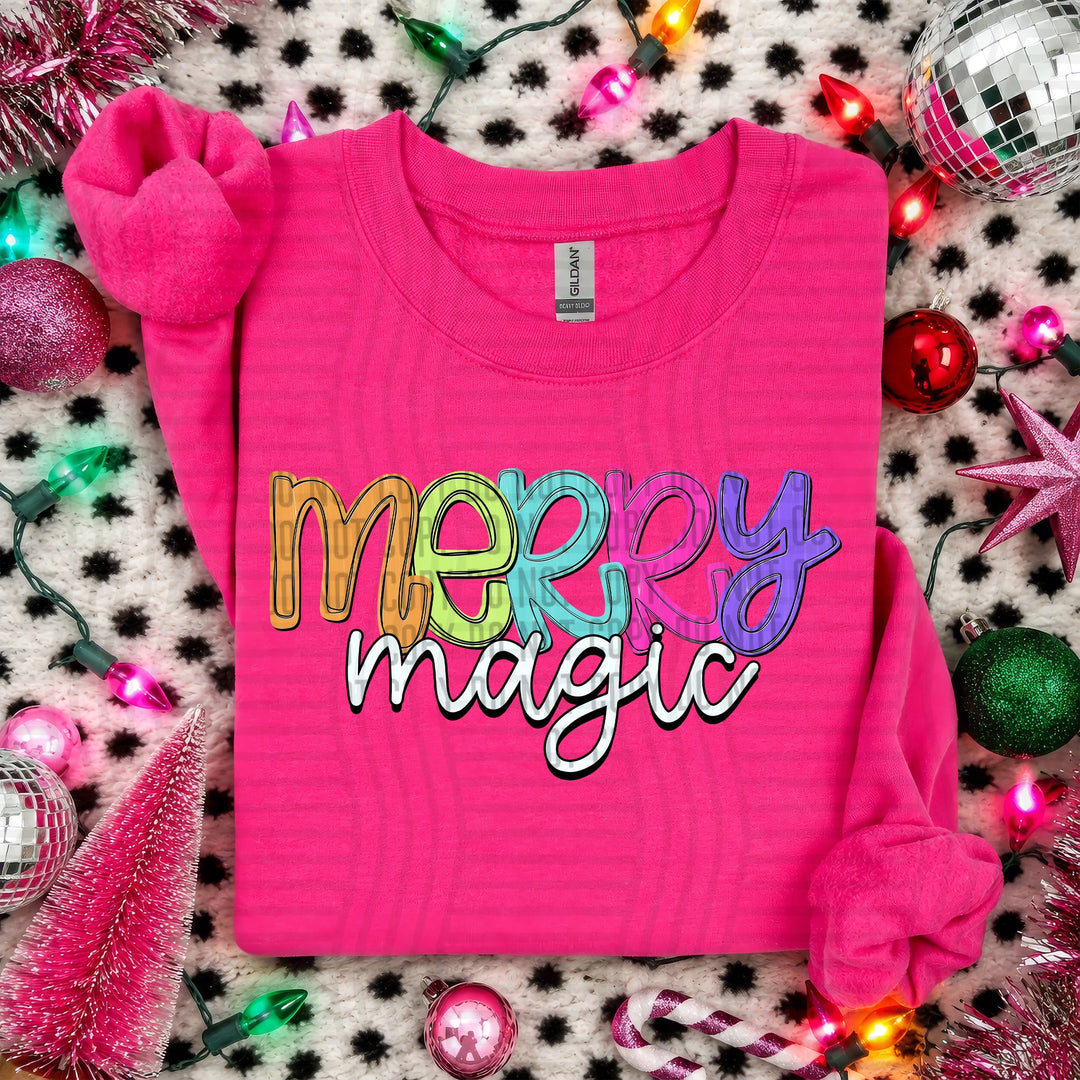 Merry Magic Script Christmas DTF transfer shown on a pink sweater